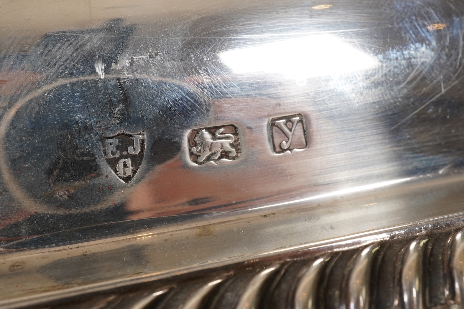 A matched pair of George V silver rectangular entrée dishes and covers, both with gadrooned borders and similar unmarked handles, Ellis & Co, Birmingham, 1923 and Ellis & Co, Birmingham, 1932, base 27.8cm, 108.3oz, exclu